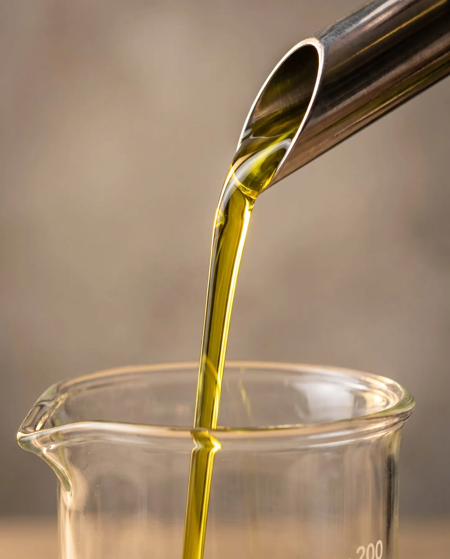 Deep green crude avocado oil being poured